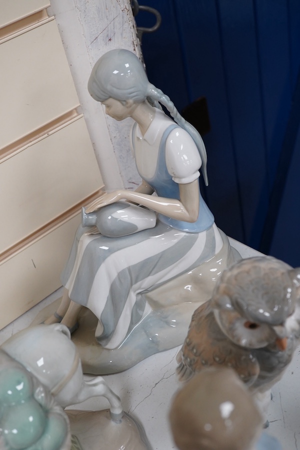 A quantity of Lladro style and Nao figures (12). Condition - good